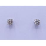 A pair of single stone diamond ear studs, each stone approx. 0.30 carat, mounted in 18 carat white