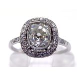 A fine early 20th century diamond ring, circa 1920, the central millgrain set rectangular cushion