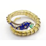 An enamel and gem set snake bracelet, the polychrome enamel head with an triangular cut emerald drop