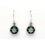 A pair of emerald, onyx and diamond earrings, the circular drops with an old mine cut to the centre,