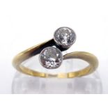 A two stone diamond ring, circa 1920, the two millgrain set old European cuts totalling approx. 0.44