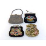 A collection of four early 20th century clutch bags, three needlepoint examples, and one beaded,