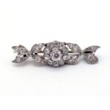 A late Victorian diamond bar brooch, circa 1900, composed of a central cluster with stylised