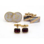 A pair of garnet set cufflinks, the two emerald cut red stones rub over set, 11mm long, the