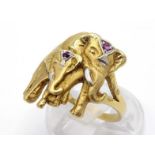 An Indian gold and ruby 'elephant' ring, depicting an adult and calf, each wearing a ruby set