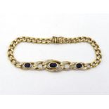 A French 18 carat gold, sapphire and diamond curb link bracelet, the central links set with three