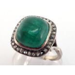 An emerald and diamond ring, the large square cushion cabochon emerald 11.3 x 10.7mm, in a