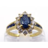 A sapphire and diamond cluster ring, the central oval cut sapphire 6 x 4mm, in a surround of small