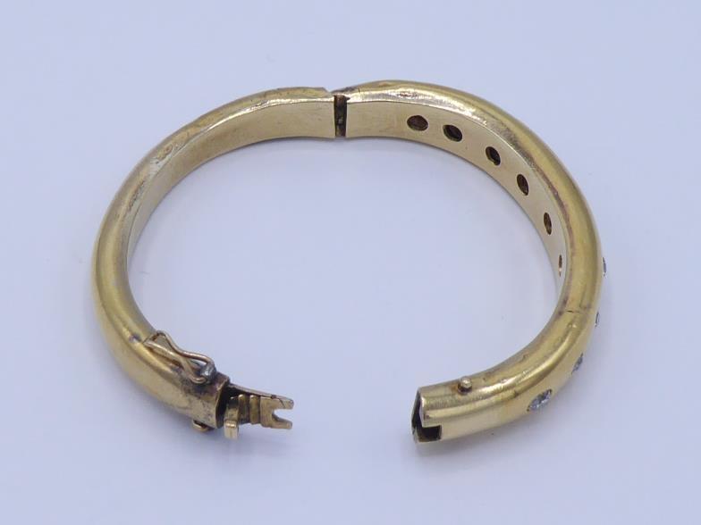 A Victorian diamond bangle, gypsy set to the front with graduated mine cuts, the central stone - Image 2 of 2