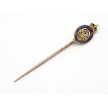 An early 20th century gold and enamel stick pin, the enamelled head depicting the Order of the