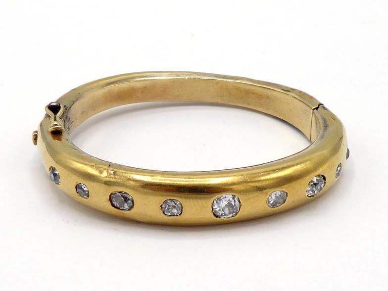 A Victorian diamond bangle, gypsy set to the front with graduated mine cuts, the central stone