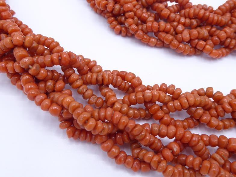 A 20th century Chinese coral and jadeite robe cord, composed of four strands of braided coral, to - Image 2 of 3