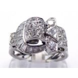 A mid 20th century diamond dress ring, the ornate buckle design set overall with single cuts and
