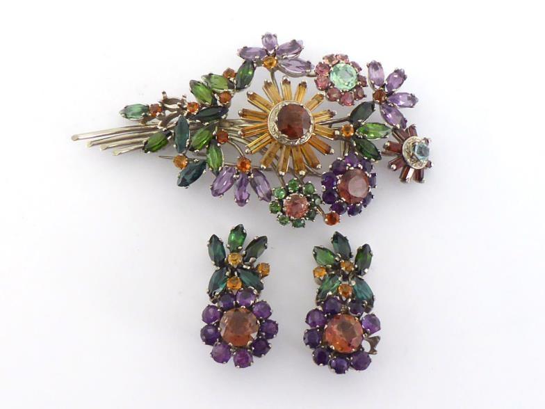 A multi gem spray brooch, the large floral spray set overall with tourmaline, amethyst, citrine