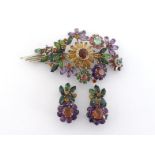 A multi gem spray brooch, the large floral spray set overall with tourmaline, amethyst, citrine