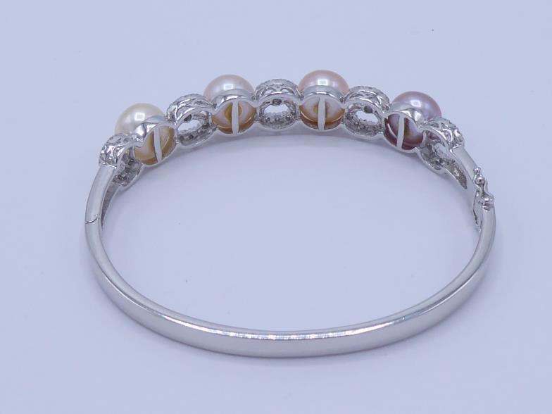 A cultured bouton pearl and diamond hinged bangle, the front set with four 9.5mm diameter pearls, - Image 2 of 4