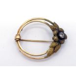 An early 20th century yellow metal (tests 14 carat gold) and paste set brooch/pendant, the round