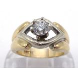 A single stone diamond ring, the central brilliant approx. 0.20 carat, claw set above a yellow