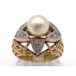 A cultured pearl and diamond ring, the central pearl 8.4mm diameter, set above a platinum flashed '