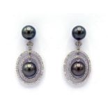 A pair of Tahitian cultured pearl and diamond earrings, each drop centred on a 10.6mm round pearl