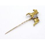 A yellow metal (tests 18 carat gold) and diamond stickpin, designed as a carousel horse, the