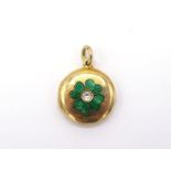 A diamond and enamel locket, the circular locket with a green guilloche enamel clover, an old cut