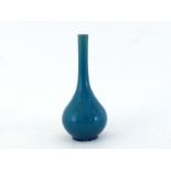 A Chinese porcelain rich turquoise glazed long neck vase, with a long slender neck above a pear