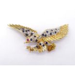 A sapphire, ruby and diamond brooch, designed as an eagle in flight, the wings pave set with small