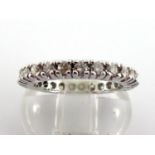 A diamond eternity ring, the band of brilliants totalling approx. 0.75 carat, the white mount