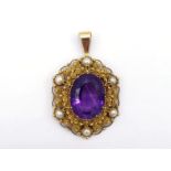 An amethyst and split pearl pendant, in the early 19th century style, the central oval cut