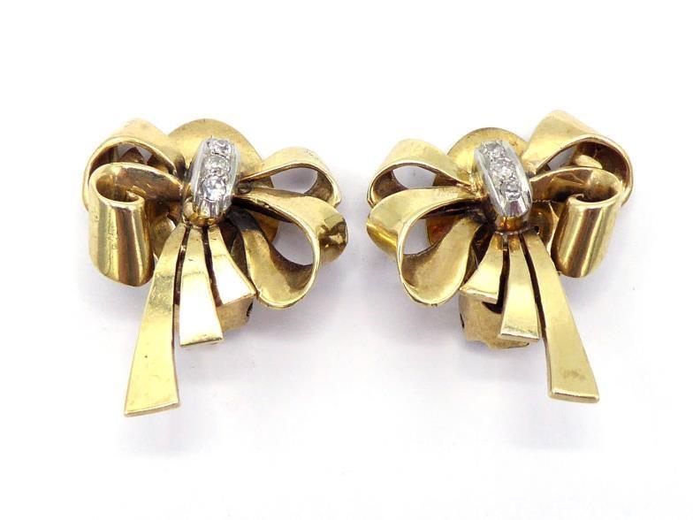 A pair of 1950s diamond ear clips, designed as a bow, three small single cuts to the centre, stamped