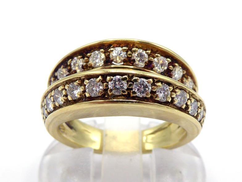 A mid 20th century diamond ring, composed of bifurcated bands, each pave set with a line of