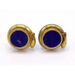 A pair of yellow metal (tests 18 carat gold) and lapis lazuli ear clips, each circular lapis panel