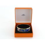 HERMES , an enamel bangle depicting fan motif with gold finish. Stamped HERMES Paris, Made in