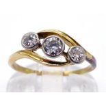 A three stone diamond ring, the three graduated old cut brilliants obliquely set in rub over mounts,