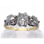A three stone diamond ring, the central old mine cut approx. 0.75 carat, flanked by two old