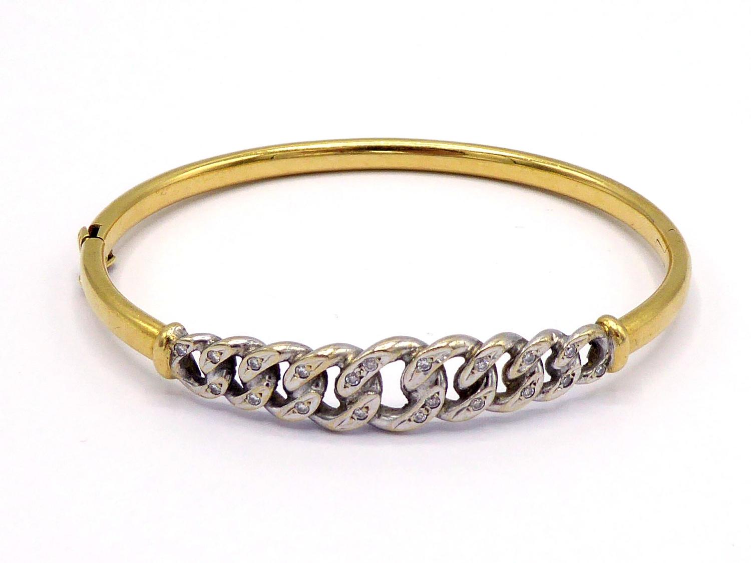 A diamond bangle, the central curb linked motif pave set overall with small brilliants, mounted in