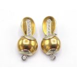 A pair of Italian 18 carat gold and diamond earrings, composed of an articulated oval top and