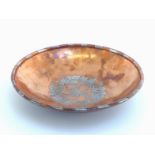 Hugh Wallis (British 1871-1943) A hand beaten heavy copper bowl with pewter inlaid floral central