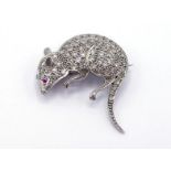 A diamond and ruby brooch, designed as a mouse, pave set overall with small single cuts, a ruby