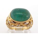 A French 18 carat gold, emerald and diamond ring, the large oval cabochon emerald 14.7 x 11mm, above