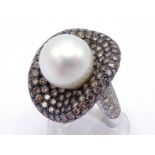 An 18 carat white gold, South Sea cultured pearl and 'champagne' diamond dress ring, the central