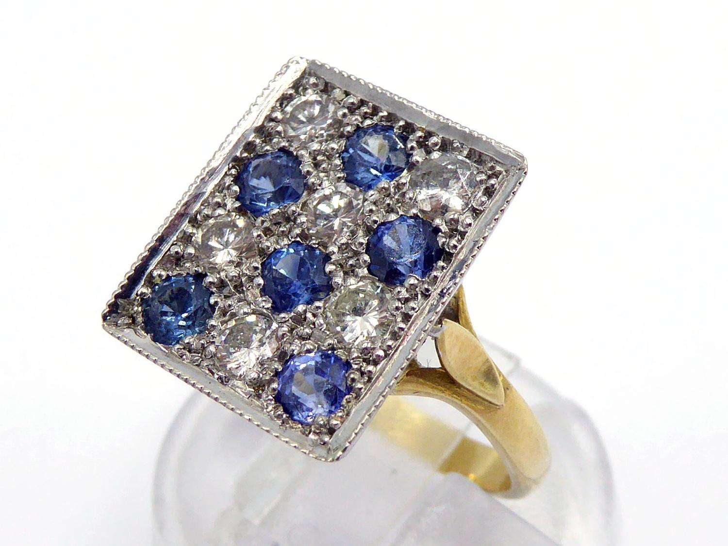 An 18 carat gold, sapphire and diamond plaque ring, composed of a rectangular checker board of