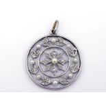 An early 20th century platinum, diamond and seed pearl pendant, composed of a wreath of millgrain