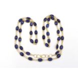 An sapphire line necklace, composed of uniform spectacle set oval sapphires, each 5 x 4mm long,