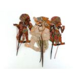 Three Indonesian articulated shadow puppets elaborately painted on both sides, pierced and with