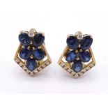 A pair of sapphire and diamond ear clips, composed of a cluster of oval cut sapphires, with a dart