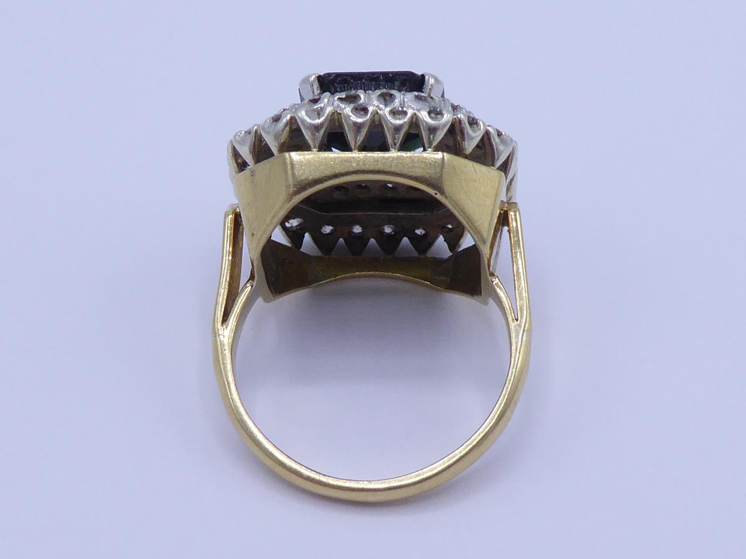 A sapphire and diamond cluster ring, the central step cut sapphire 11 x 10mm, claw set above a - Image 3 of 4