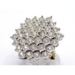 A diamond cluster dress ring, composed of a large snowflake cluster of illusion set brilliants,