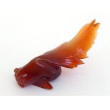 A long tailed goldfish carved in brown agate. Length 8.5cm.